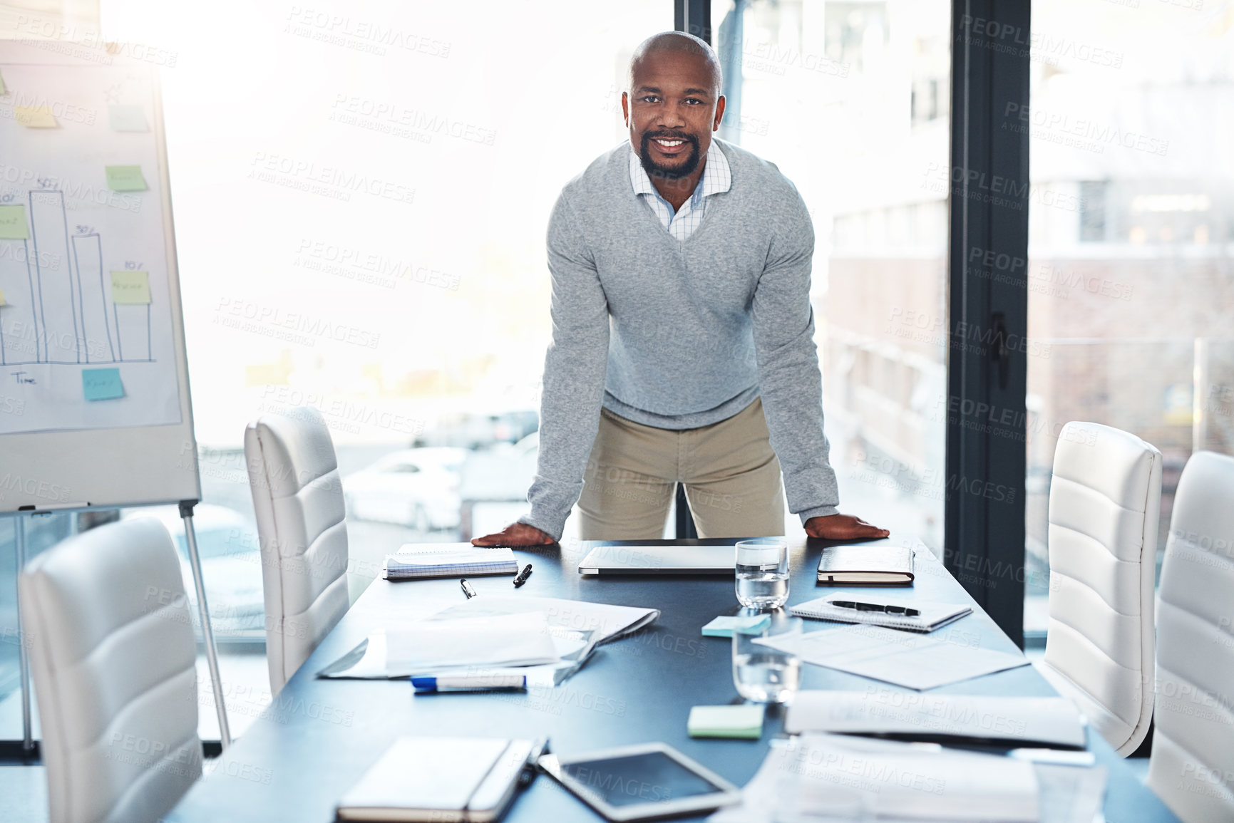 Buy stock photo Portrait of a handsome mature man standing at the head of the boardroom table