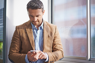 Buy stock photo Office, window and man checking phone for networking, email or scroll on social media. Communication, tech startup and businessman on smartphone for consulting, business connection or online chat