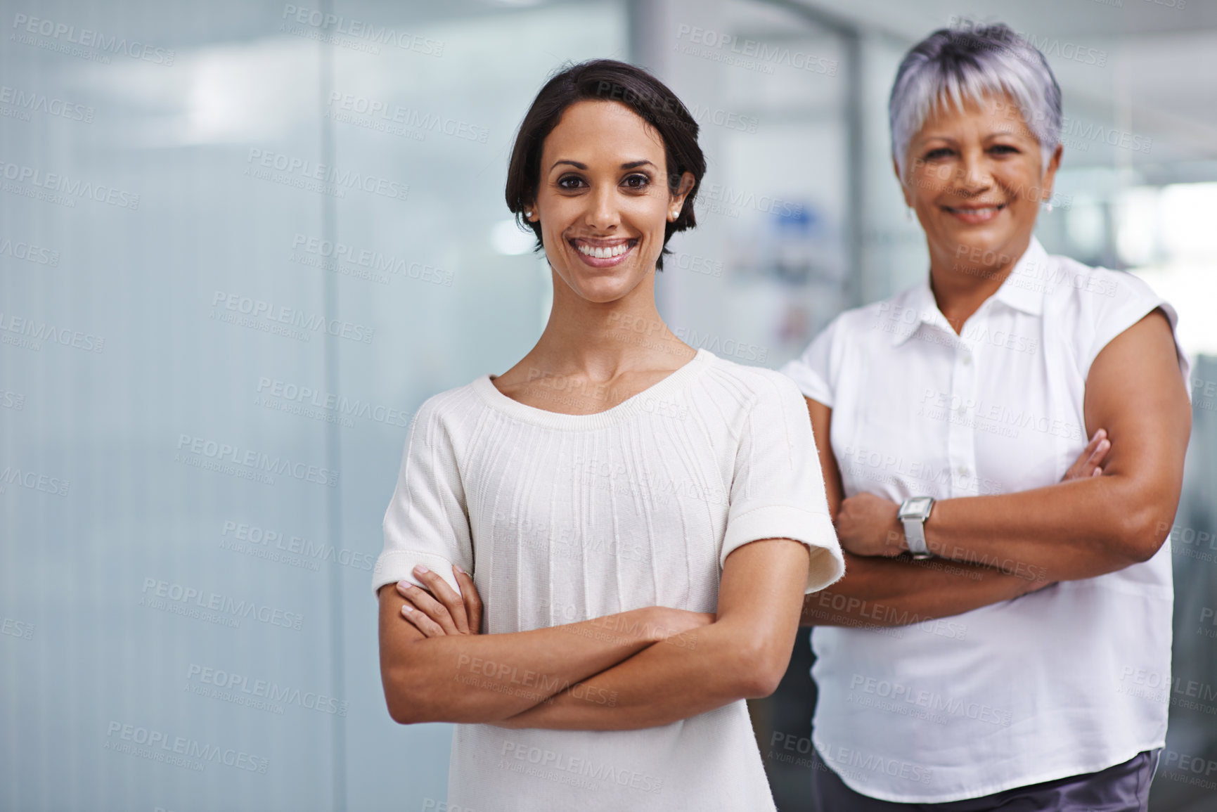 Buy stock photo Portrait of two businesswomen posing in their office together