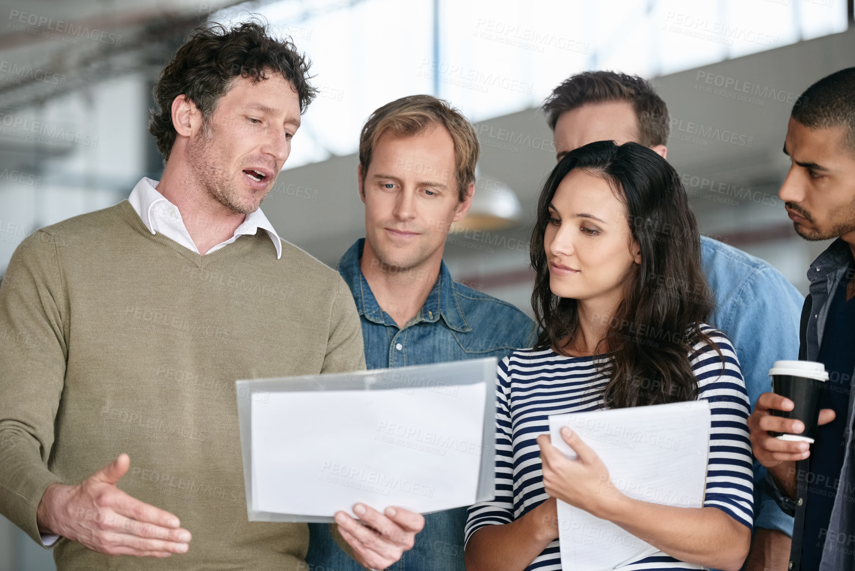 Buy stock photo Creative man, paperwork and meeting with team for collaboration, ideas or planning at office. Group employees listening to speaker or presenter with documents for brainstorming startup at workplace
