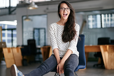 Buy stock photo Portrait of a laughing young woman sitting in a chair in a modern office