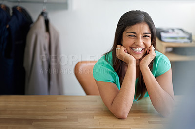 Buy stock photo Portrait of a smiling young female designer sitting at her desk in an office