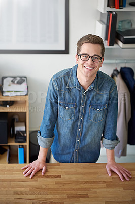 Buy stock photo Portrait of a smiling young male designer standing at her desk in an office