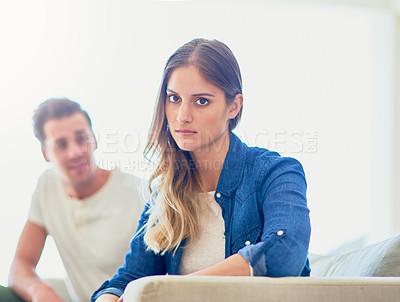 Buy stock photo Portrait of an attractive young woman giving her husband the silent treatment after a fight