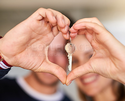 Buy stock photo Portrait of a happy young couple proudly displaying the keys to their new house