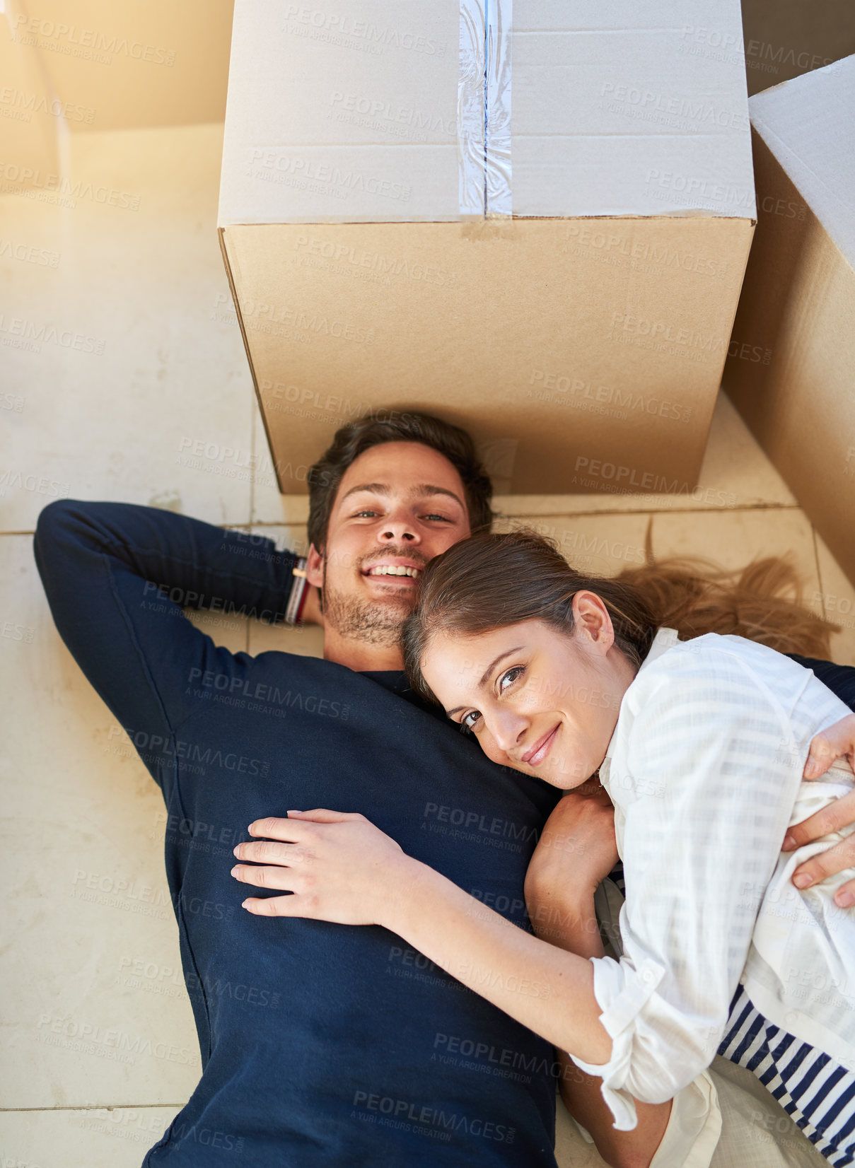 Buy stock photo Portrait of a happy young couple resting on the floor while moving into their new house