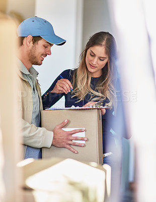 Buy stock photo Shot of a delivery man making a delivery to a happy customer at her home