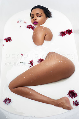 Buy stock photo Portrait of a beautiful young woman submerged in white liquid in a bathtub