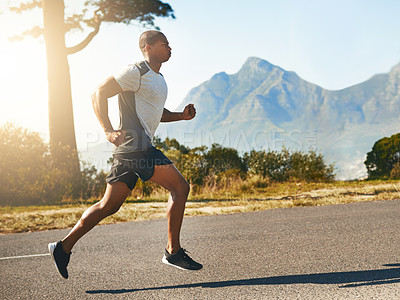 Buy stock photo Shot of a fit young man going for a run outdoors