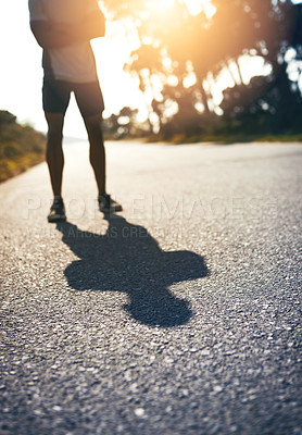 Buy stock photo Road, wellness and person with confidence for fitness, exercise and ready for marathon challenge. Legs, male athlete and runner with preparation for training, outdoor and healthy living by sunset