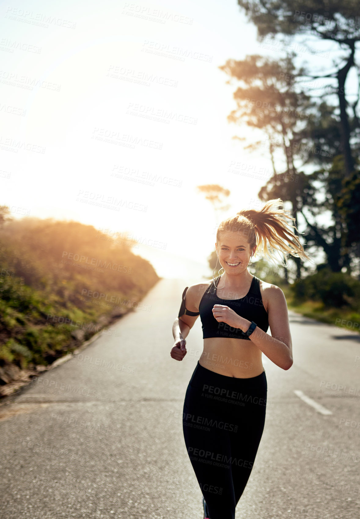 Buy stock photo Running, fitness and portrait of woman for outdoor training, cardio workout or endurance challenge. Lens flare, sports and athlete person in road for exercise, marathon or performance in California