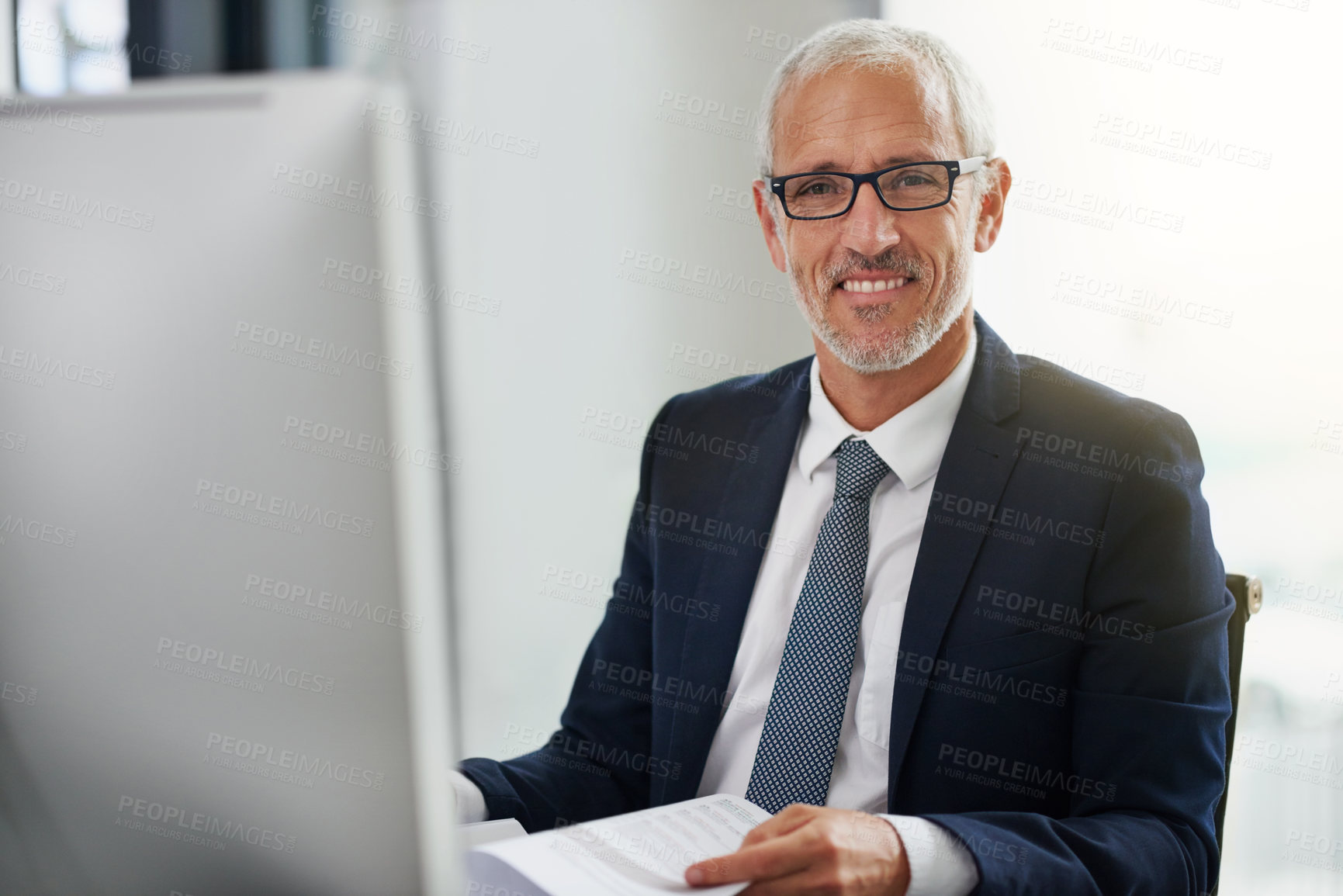 Buy stock photo Portrait, ceo and businessman at desk in office, computer and eyewear in workplace. Research, book and reading for attorney or law firm manager, happy and male person and planning for legal case