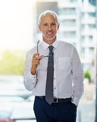 Buy stock photo Portrait of a smiling mature businessman standing in an office