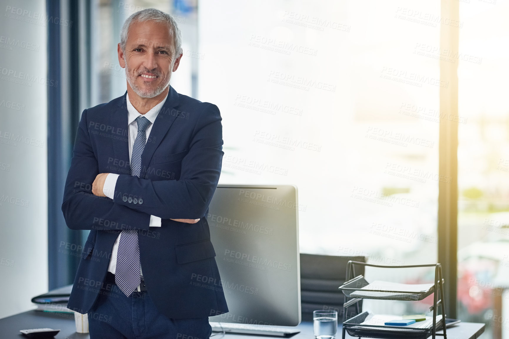 Buy stock photo Portrait of a smiling mature businessman standing in an office