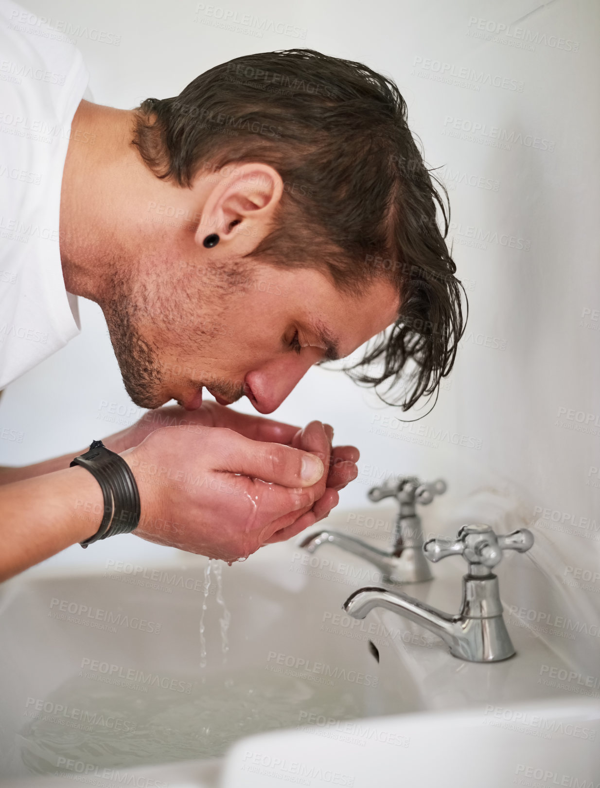 Buy stock photo Tap, washing face and man with water in bathroom for grooming, skincare or morning routine in home. Wet, wellness and male person for clear skin, cleaning treatment or personal hygiene in apartment