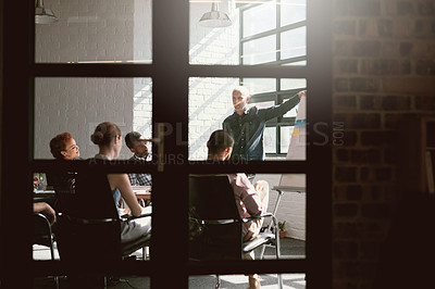 Buy stock photo Shot of a group of businesspeople meeting in the boardroom