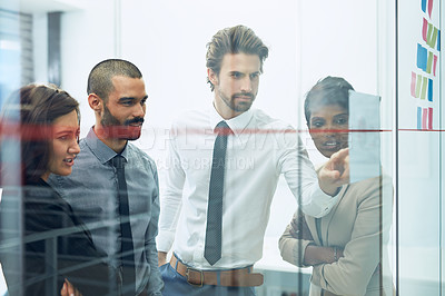 Buy stock photo Shot of colleagues brainstorming in the office
