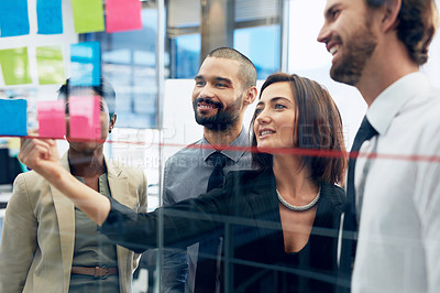 Buy stock photo Teamwork, collaboration of diverse coworkers with sticky notes on wall and working in office. Startup or project, support or communication and team planning together discussing plans or ideas at work