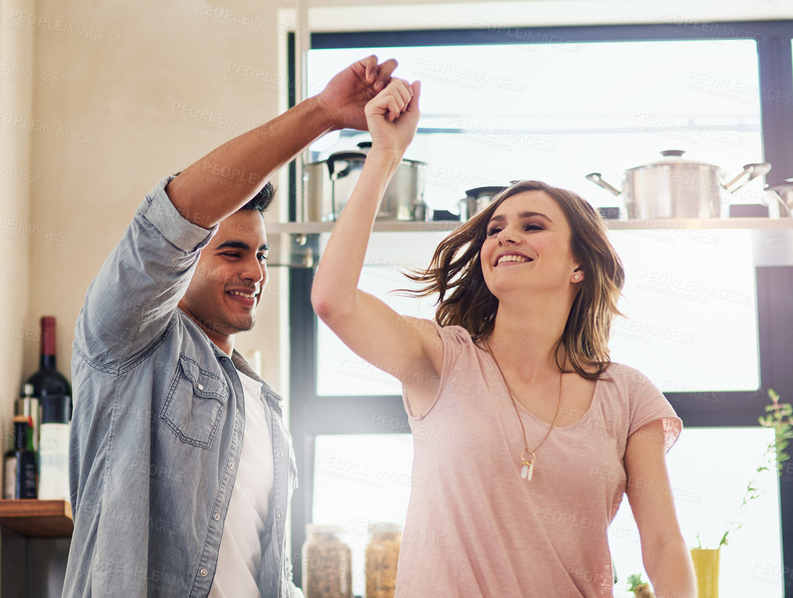 Buy stock photo Couple, people and happy with dancing in kitchen to relax for bonding, love and support on break together. Home, relationship and romance with smile or laugh for fun, enjoy and care as soulmate