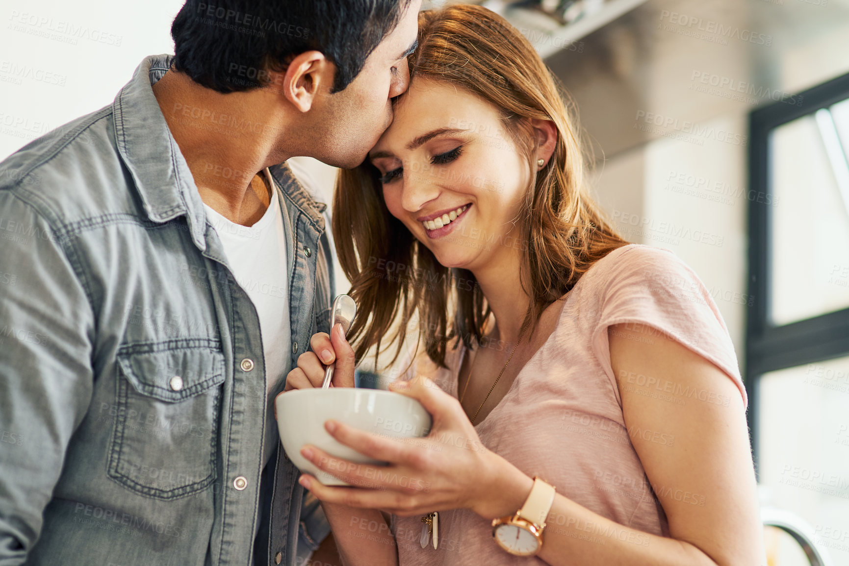 Buy stock photo Couple, kiss and love in house with breakfast for relationship, date and time together in living room. Man, woman and support with happy, food and smile in home for connection, care and commitment
