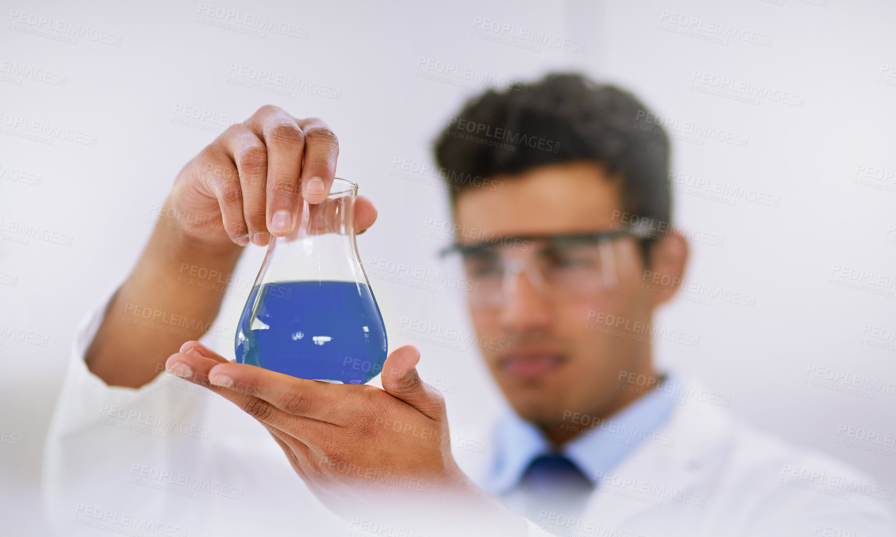 Buy stock photo Glass beaker, research and man scientist in laboratory with blue liquid for chemistry experiment. Science, career and professional male researcher with chemical fluid work on pharmaceutical project.