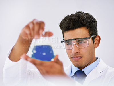 Buy stock photo Chemical, face and solution with scientist man in studio on white background for laboratory study. Beaker, liquid and safety goggles with person in lab coat for breakthrough, innovation or research