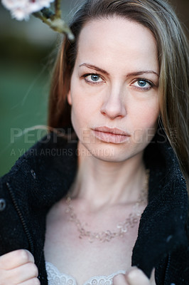 Buy stock photo Cropped portrait of an attractive woman posing outside
