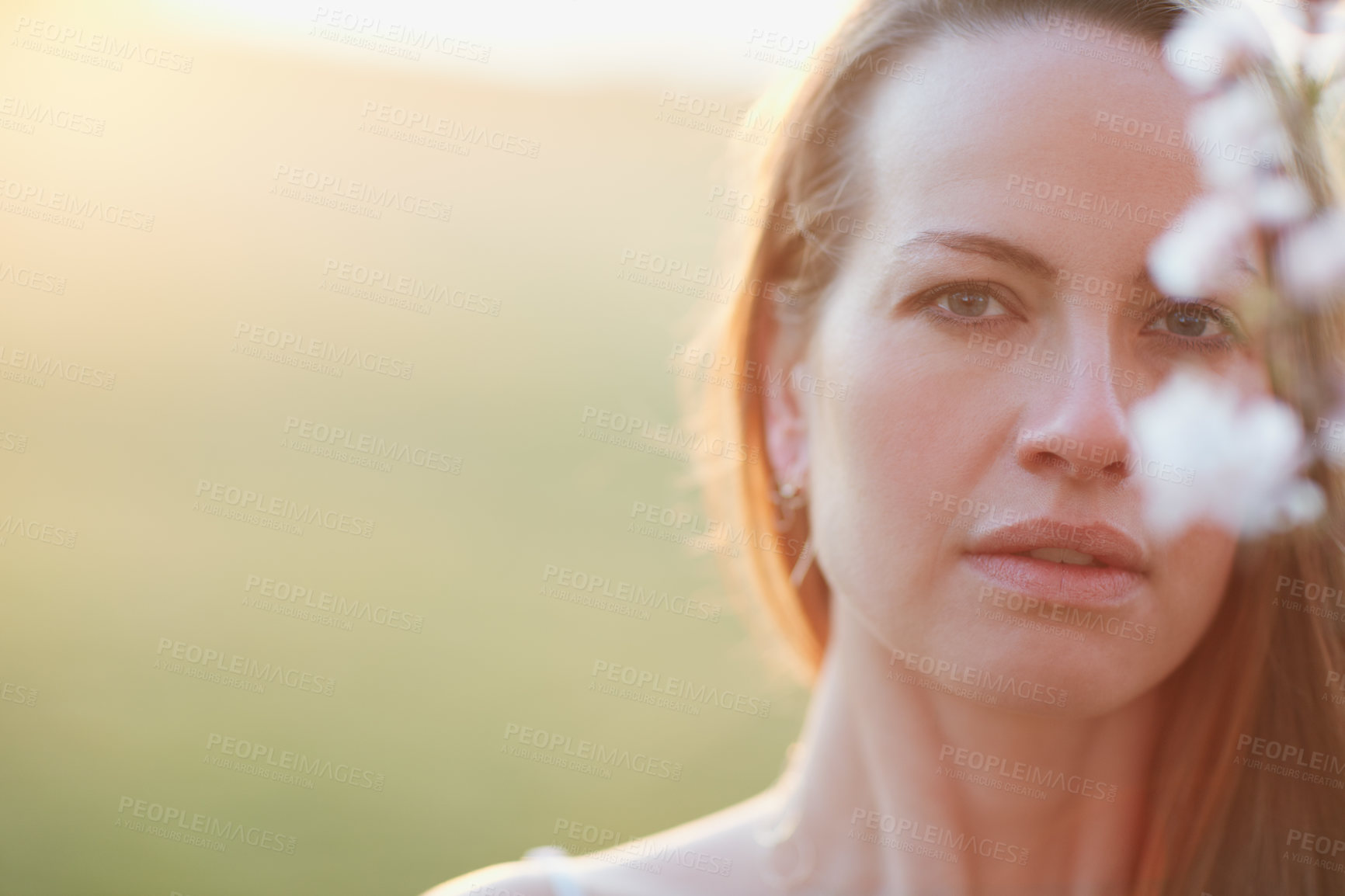 Buy stock photo Cropped portrait of an attractive woman posing outside