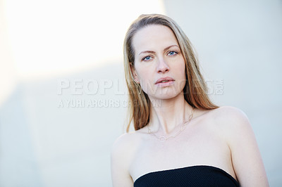 Buy stock photo Cropped portrait of an attractive woman posing outside