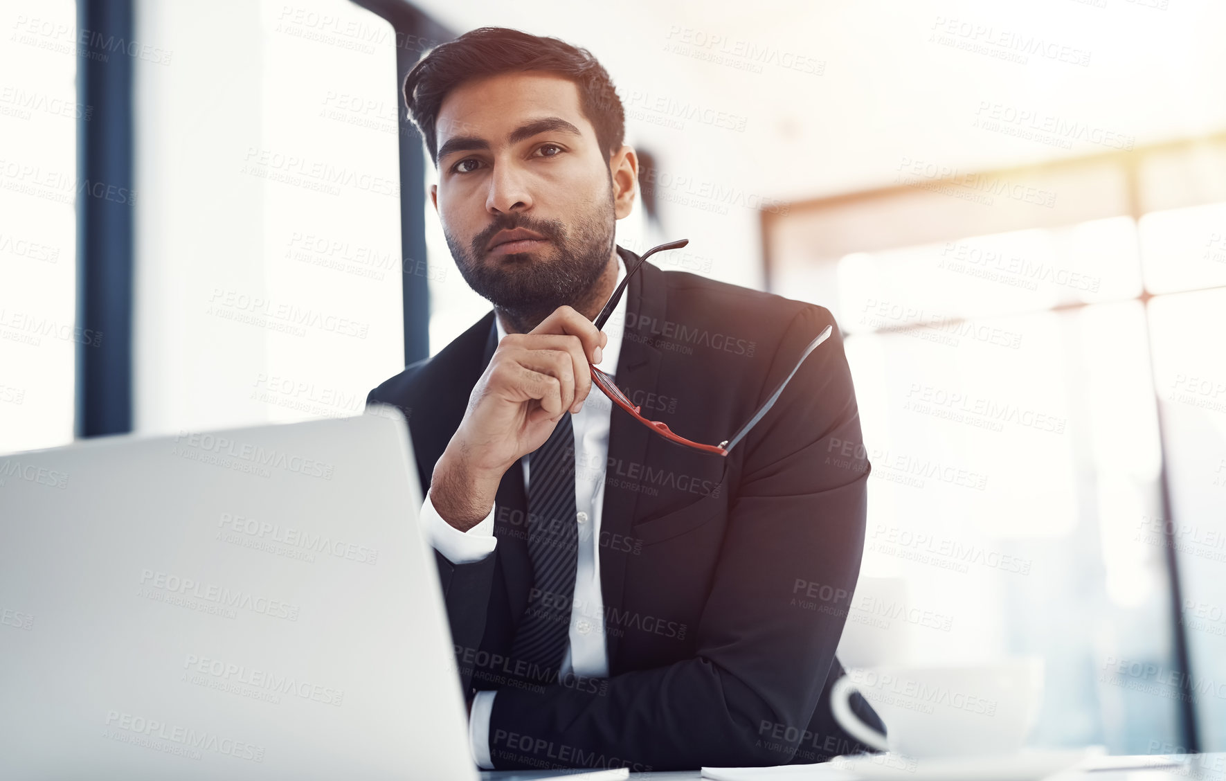 Buy stock photo Businessman, serious and portrait with laptop at desk for case research, administration and contract review. Professional, lawyer and pride at firm for online consulting and planning legal proposal