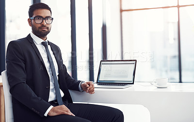Buy stock photo Cropped shot of a young businessman sitting at his desk