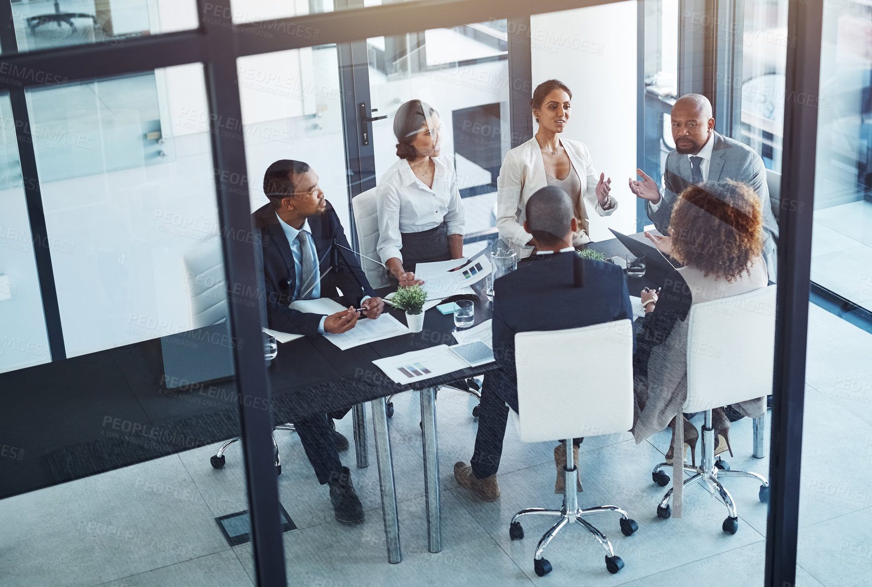 Buy stock photo Conversation, business people and team in a meeting for discussion, brainstorming or planning in office. Teamwork, group and corporate colleagues working on a project together in workplace boardroom.