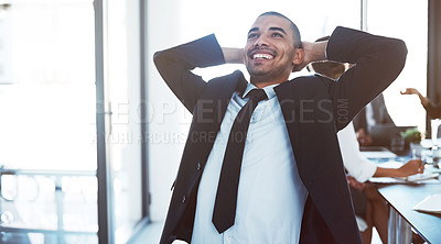 Buy stock photo Shot of a happy young businessman relaxing during a meeting at work
