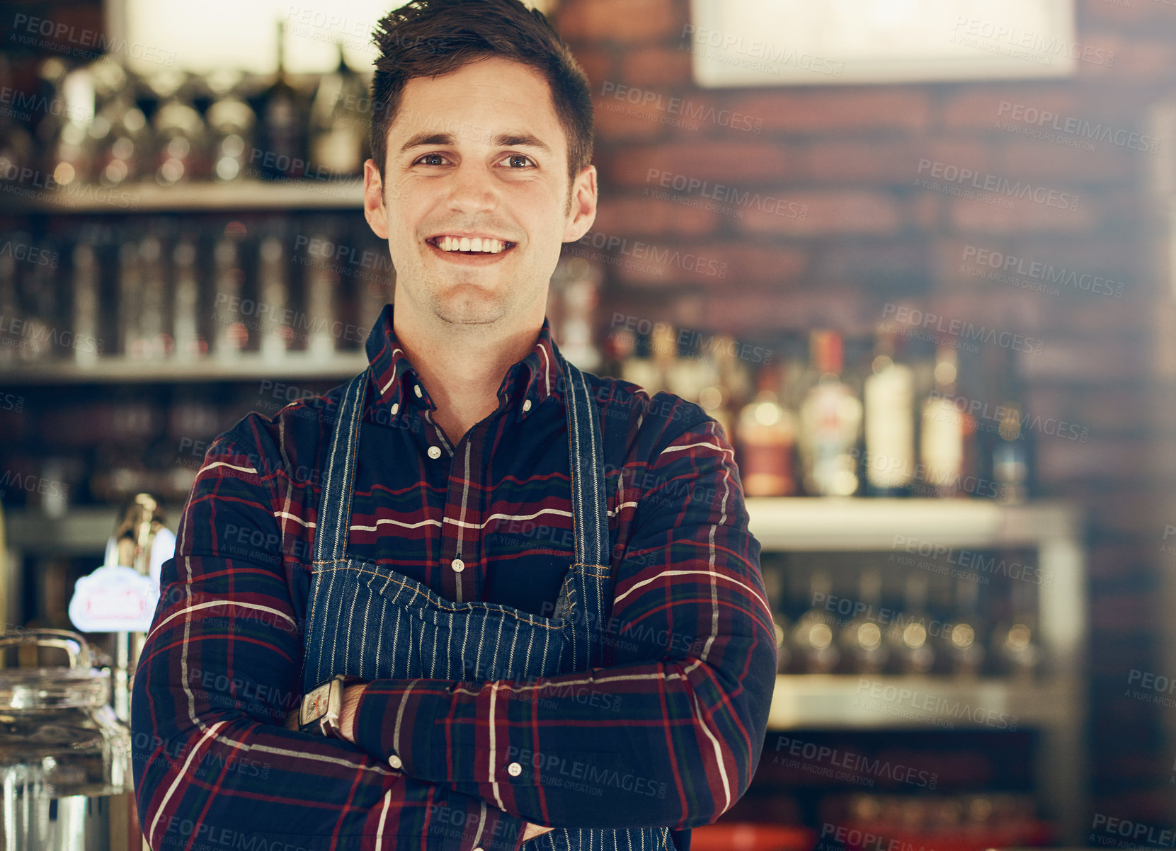 Buy stock photo Portrait of a smiling young entrepreneur standing in a small restaurant
