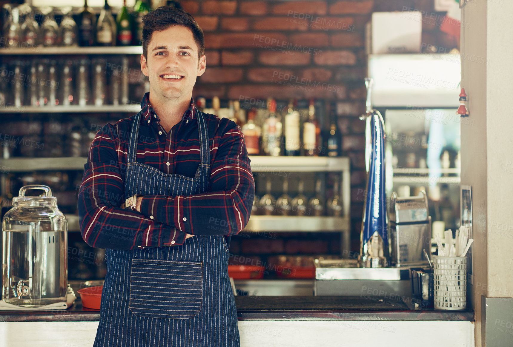 Buy stock photo Portrait of a smiling young entrepreneur standing in a small restaurant