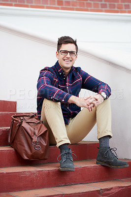 Buy stock photo Portrait of a handsome young man sitting on some steps outside