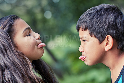 Buy stock photo Shot of a young brother and sister teasing each other while playing outside