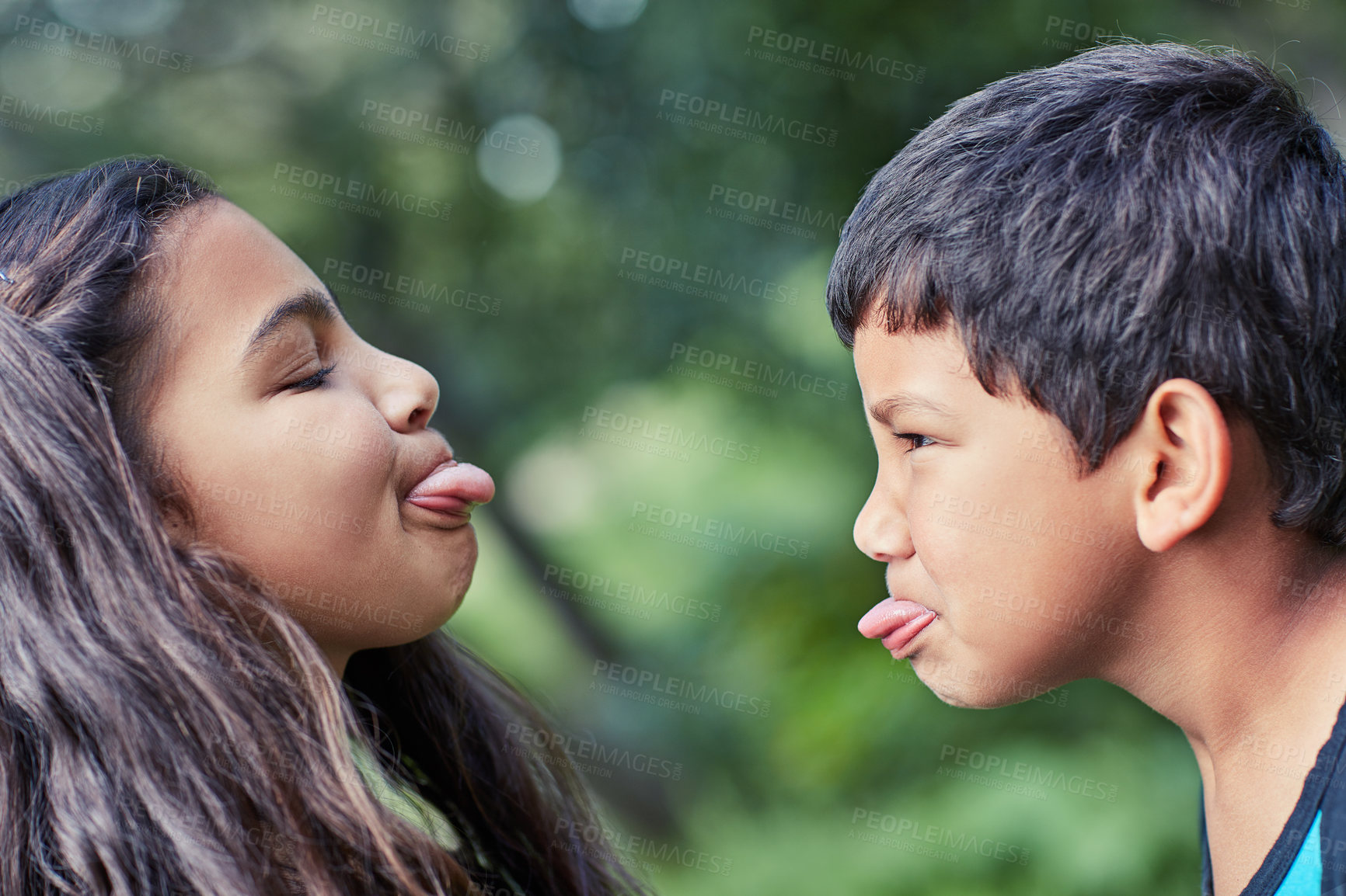 Buy stock photo Shot of a young brother and sister teasing each other while playing outside