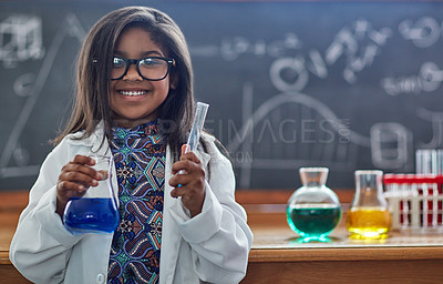Buy stock photo Portrait of a little girl in a lab coat doing a science experiment in a lab