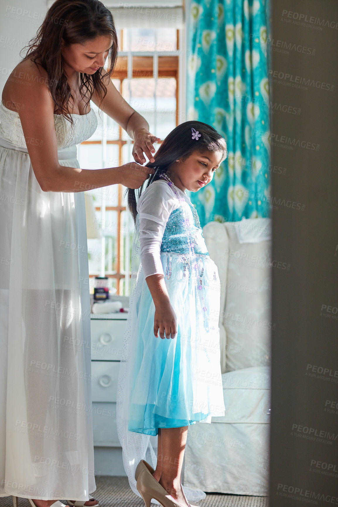 Buy stock photo Shot of a mother and her daughter playing dress up at home together