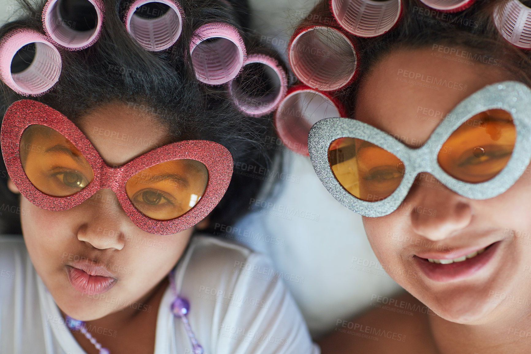 Buy stock photo Portrait of a mother and her little girl wearing sunglasses and curlers at home