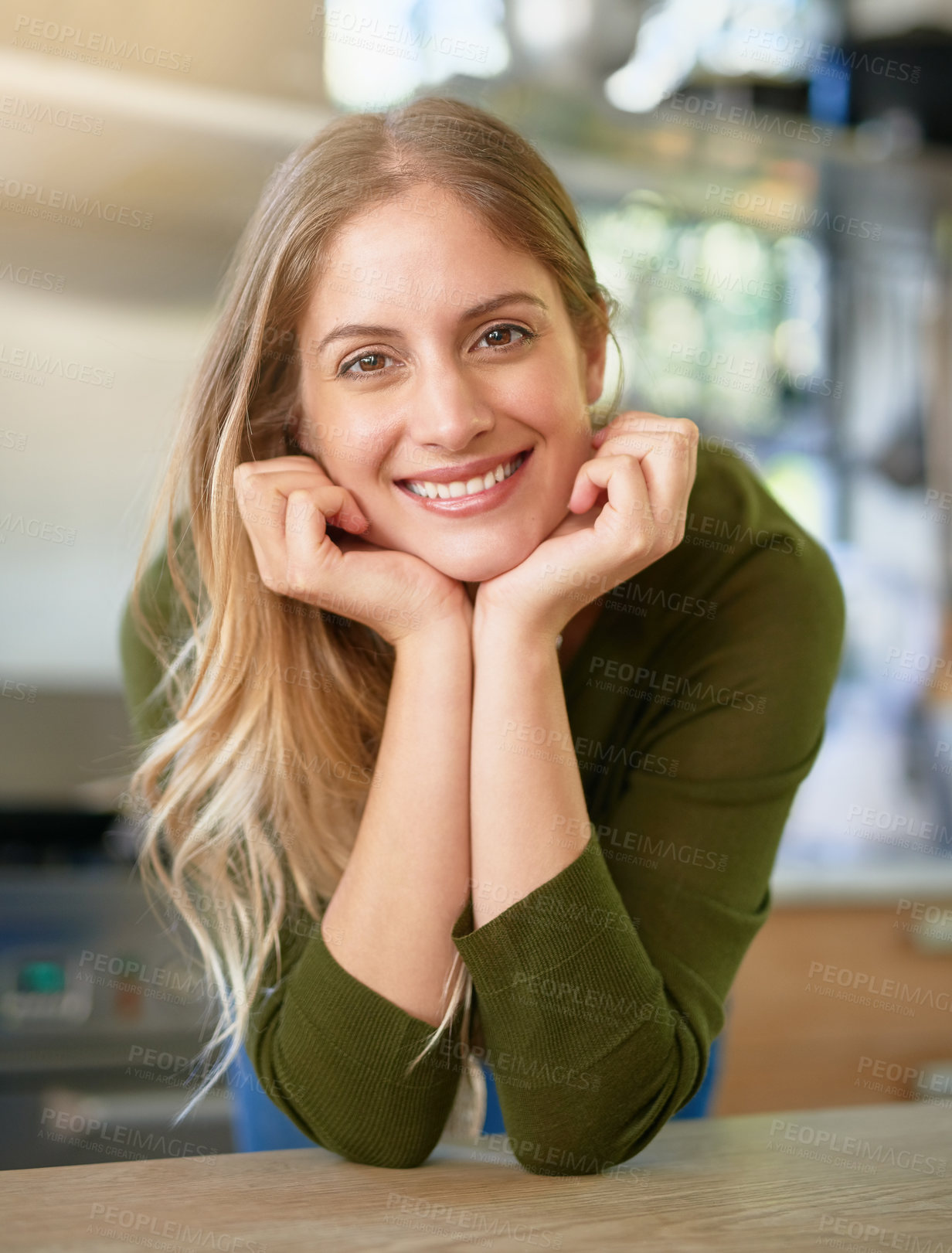 Buy stock photo Portrait of a smiling young woman leaning on her kitchen counter at home