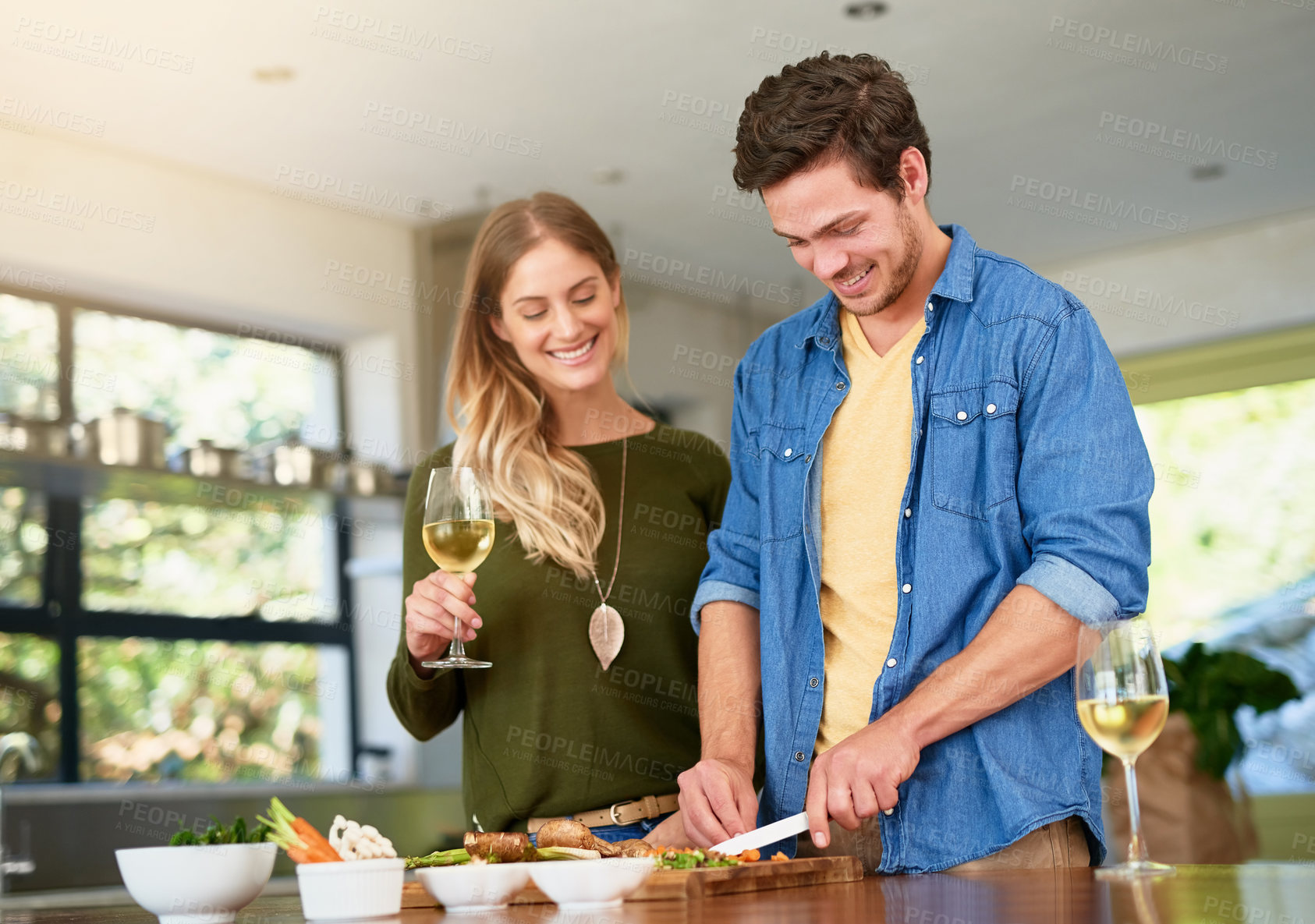 Buy stock photo Vegetables, chopping and couple with knife, kitchen counter and cooking for dinner on wood board. House, champion and people with smile for nutrition, woman and man with meal prep of healthy food