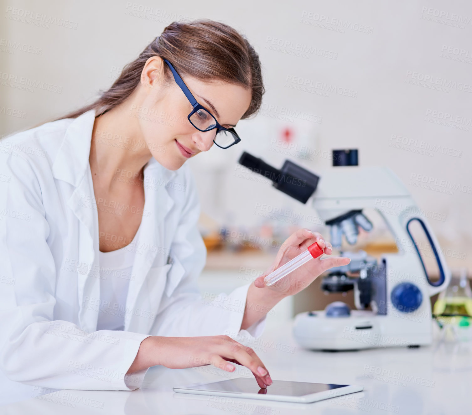 Buy stock photo Shot of a scientist using a digital tablet and microscope while sitting in a laboratory