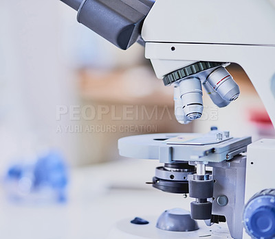 Buy stock photo Closeup shot of a microscope and equipment on a bench in a laboratory