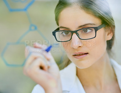 Buy stock photo Closeup shot of a scientist writing formulas on a glass wall