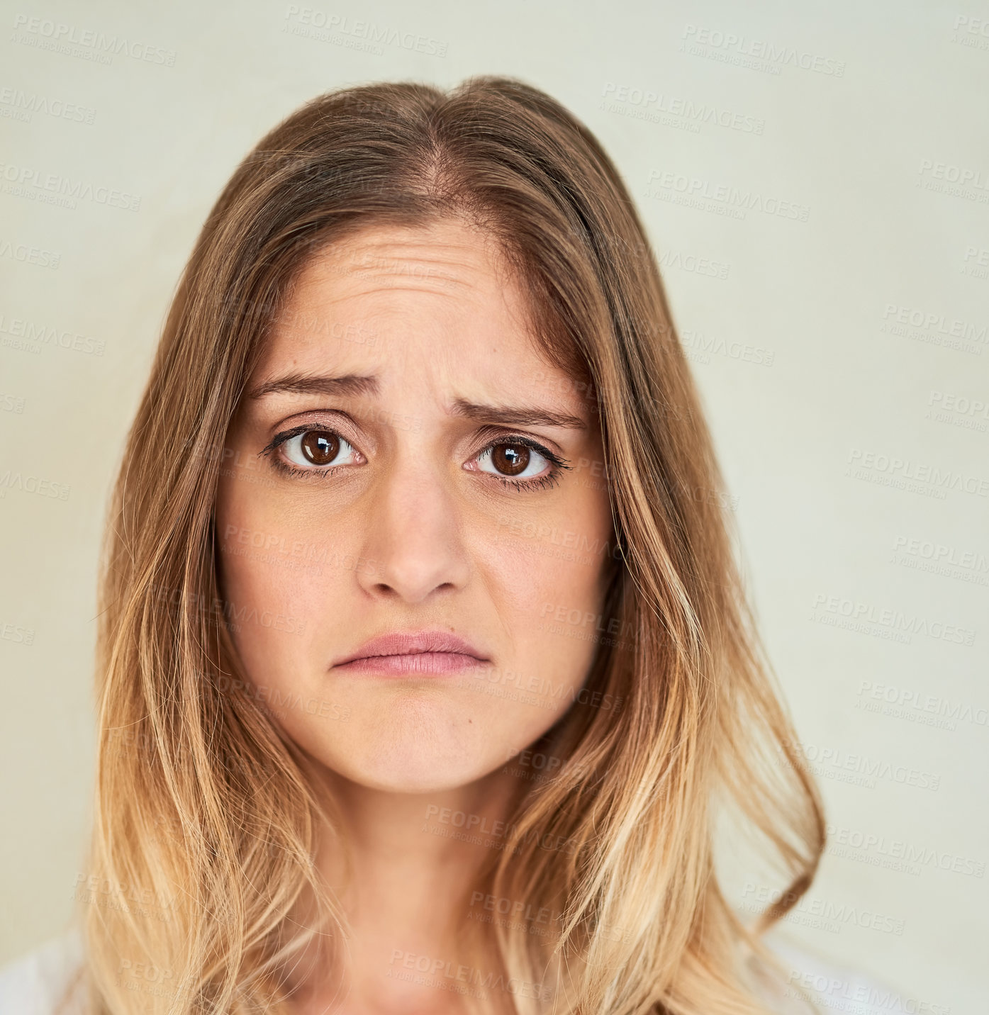 Buy stock photo Portrait of a young woman making a face in studio