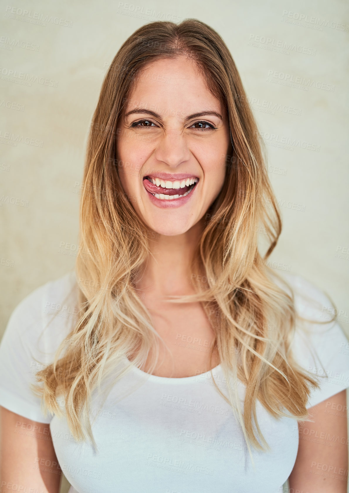 Buy stock photo Portrait of an attractive young woman sticking out her tongue