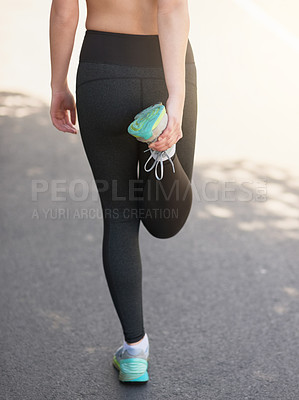 Buy stock photo Rearview shot of an unrecognizable young woman stretching before a workout
