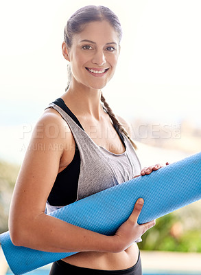 Buy stock photo Portrait of an attractive young woman carrying her yoga mat to class